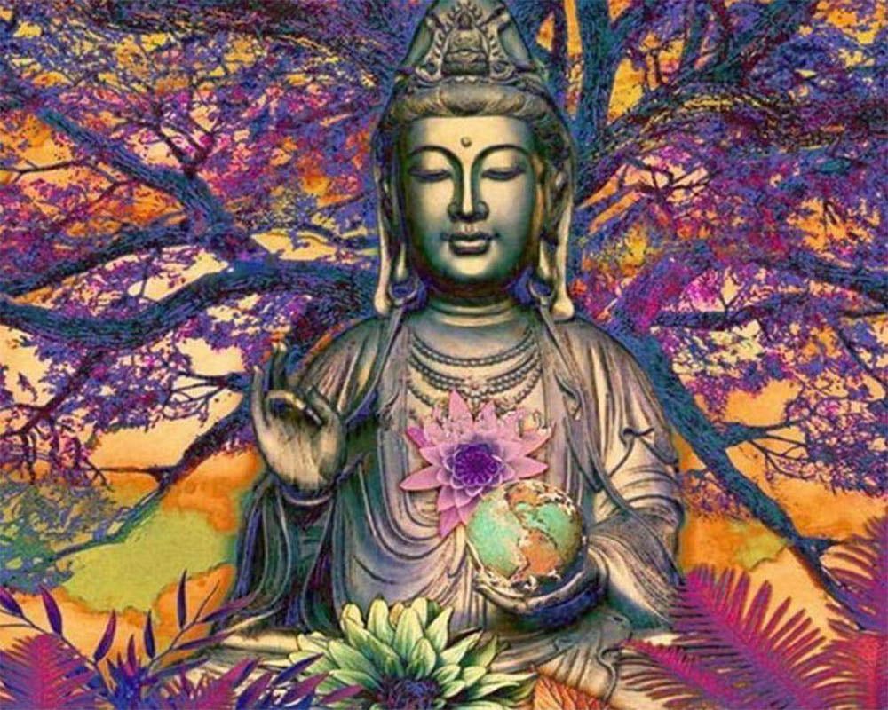 Buddha statue in front of a large tree