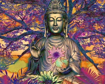 Buddha statue in front of a large tree