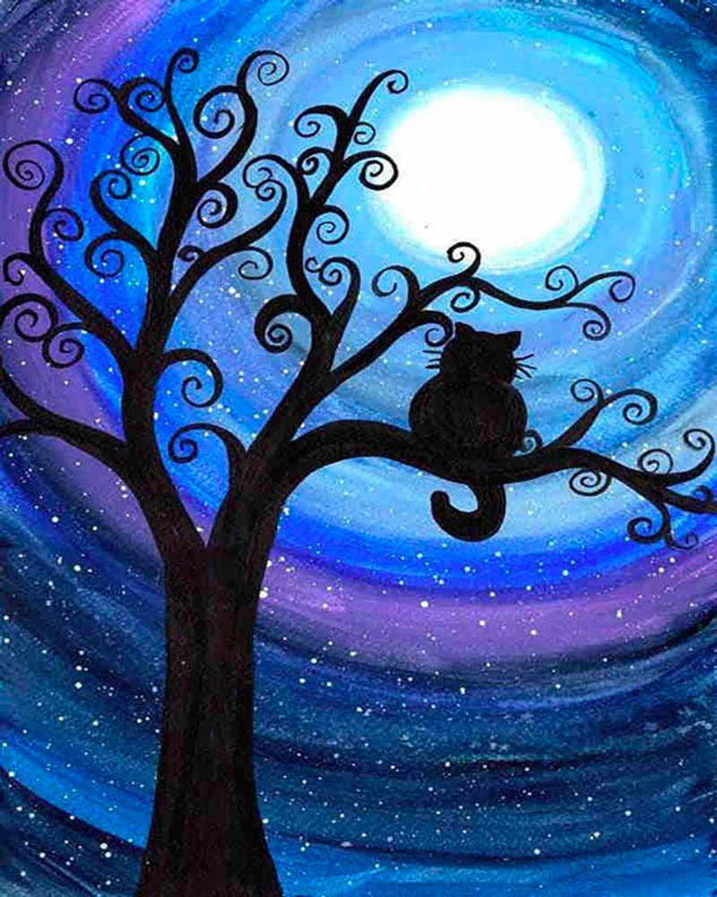 Cat at night on a branch